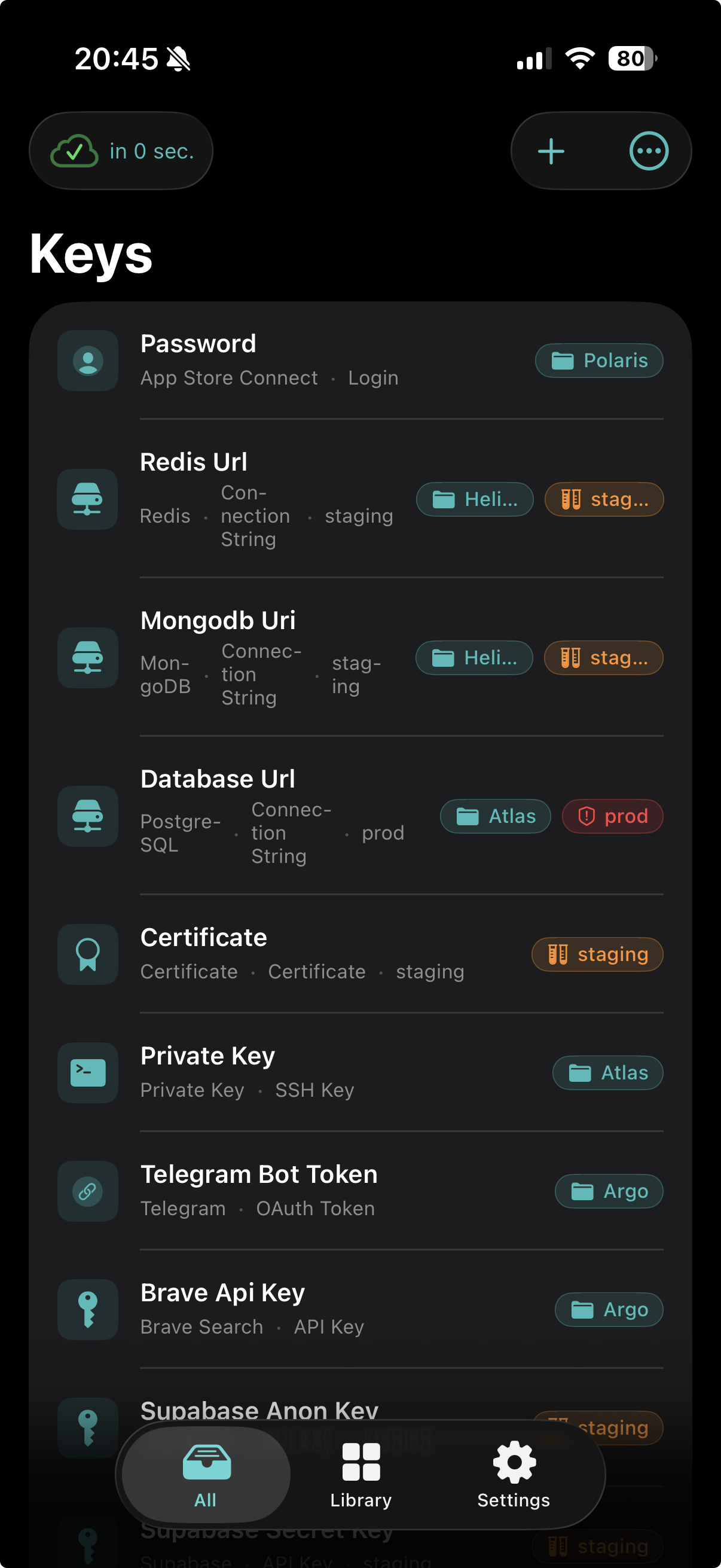 Keys home screen on iPhone — credentials list with tags and environments.
